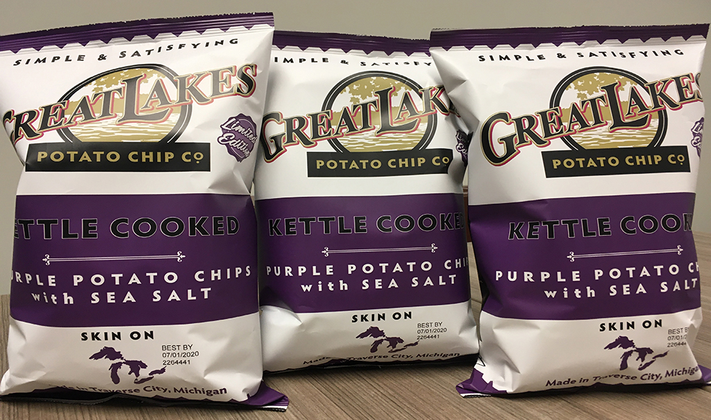 Bags of purple potato chips. 